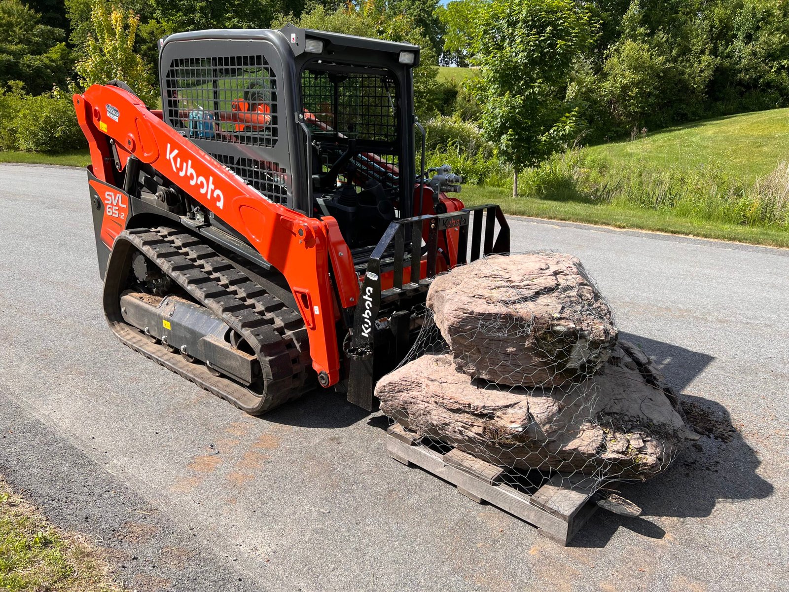kubota track loader heavy equipment with boulders