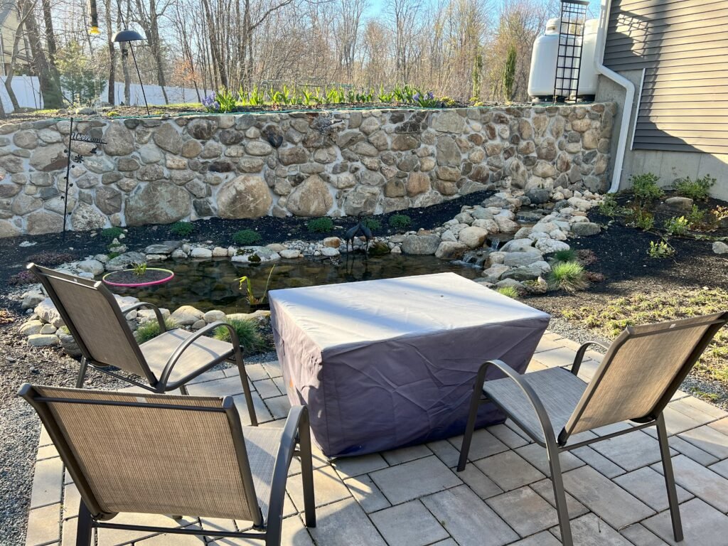 Seating area by a koi pond in Merrimac MA