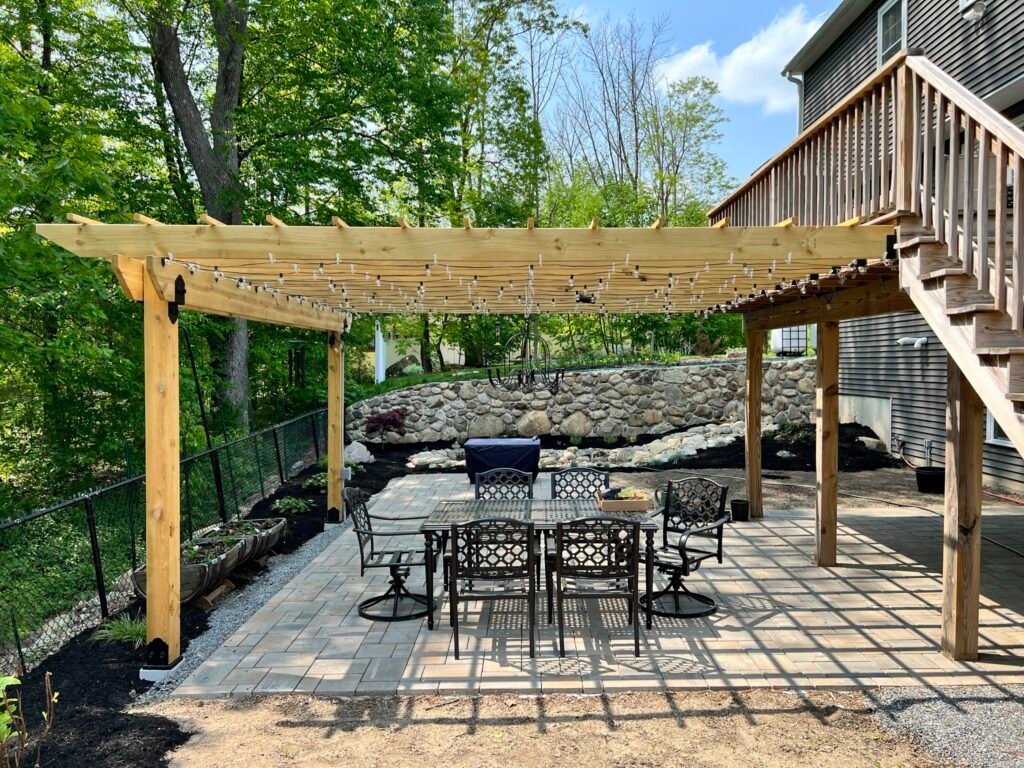 Merrimac MA Outdoor patio with pergola and seating.